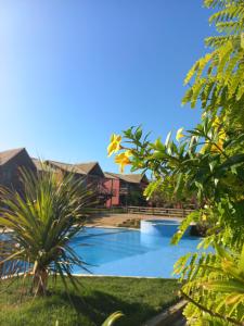 a view of a swimming pool in a resort at Chaleville Coqueiro 1001 in Luis Correia