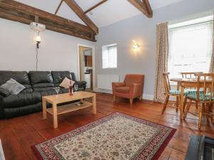 a living room with a couch and a table at The Grey Bull Apartment in Hexham