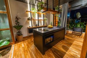 a kitchen with a island in a room with plants at Danta Santa Lofts in Fortuna