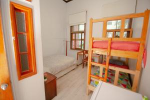 a room with two bunk beds and a bedroom at Hospedaje y Espacio Cultural La Casa Del Puerto, Cerro Alegre in Valparaíso