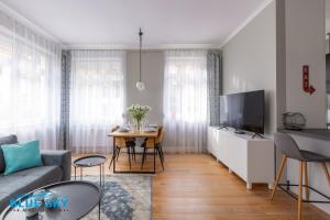 a living room with a couch and a table at Apartament Blue Sky Jelenia Góra - blisko centrum in Jelenia Góra