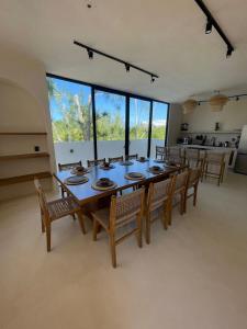 a large dining room with a table and chairs at Casa Hood By the Sea in Holbox Island