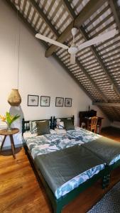 a bedroom with a large bed with a ceiling fan at Sukomala Imaduwa in Ahangama