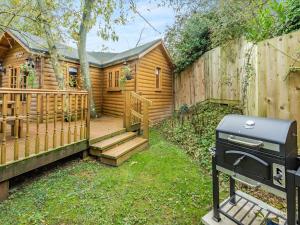 a backyard with a wooden cabin with a grill at Bear House- Uk45704 in Brinkley