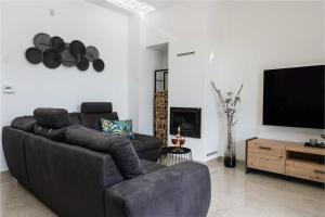 a living room with a couch and a flat screen tv at Villa More in Krk