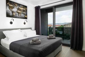 a bedroom with a bed with two towels on it at Villa More in Krk +35 photos