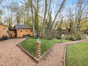 a backyard with a log cabin and a garden at Bear House- Uk45704 in Brinkley