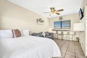 a bedroom with a white bed and a ceiling fan at Intracoastal view Family Getaway Downtown in Hollywood