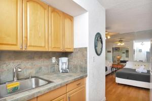 a kitchen with a sink and a room with a bed at Intracoastal view Family Getaway Downtown in Hollywood