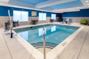 a pool in a hospital room with chairs and tables at Hampton Inn Monticello, Ny in Monticello