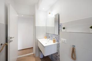 a white bathroom with a sink and a mirror at Rosa dei Venti - Centro Storico in Varazze +16 photos