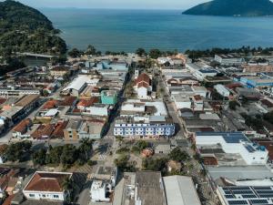an aerial view of a town next to the ocean at Hotel São Charbel in Ubatuba