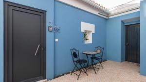 a room with a blue wall with a table and chairs at Noah's Ark by LovelyStay in Cascais +58 photos