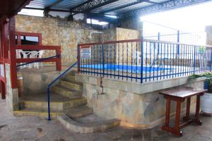 a staircase in a building with a swimming pool at Hotel São Charbel in Ubatuba