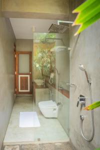 a bathroom with a glass shower with a toilet at Villa V Kalutara in Wadduwa