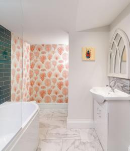 a white bathroom with a shower and a sink at Lux Mews House Portobello 4 bed in London