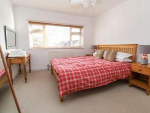 a bedroom with a bed and a desk and a window at Rainbows End in Chester