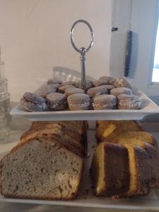 a tray of different types of bread and pastries at Pumahuasi Hotel Boutique in Purmamarca