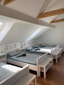 a room with four beds in a attic at HOSTEL VANEČA in Puconci
