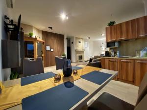 a kitchen and living room with a table and chairs at Angel's Apartment in Banská Bystrica