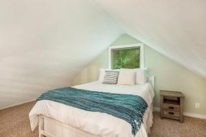 a bedroom with a bed and a window at Waterfront Newaygo Cottage with Private Dock and Beach in Newaygo