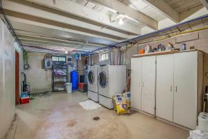 a garage with a washer and dryer in it at Waterfront Newaygo Cottage with Private Dock and Beach in Newaygo