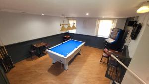 a living room with a pool table in the middle at Dryburgh Arms Pub with Rooms in Melrose