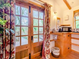 a kitchen with a wooden door and a window at Lion House- Uk45705 in Brinkley
