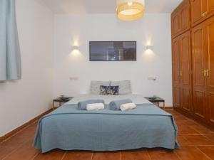 a bedroom with a blue bed with two pillows at Cubo's La Maison de Mily in Villafranco de Guadalhorce +32 photos