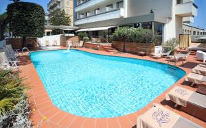 a large swimming pool in the middle of a building at National Hotel in Rimini