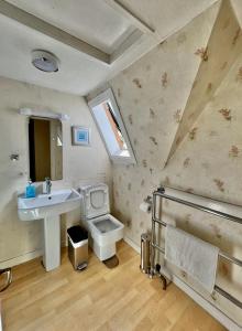 a bathroom with a sink and a toilet at Victorian Chapel House in Arisaig