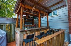 a wooden bar with chairs on a deck at CastleRooms Homestay in Ottawa