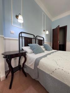 a bedroom with a large bed and a table at La Stazione di Posta in Cassino