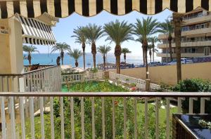 a view of the beach from the balcony of a resort at El Yate Sol y Mar in Aguadulce