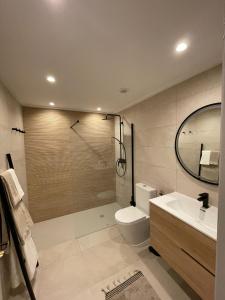 a bathroom with a shower and a toilet and a sink at Amazing vue mer CASAZAZA in Benitachell