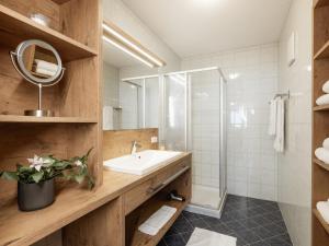 a bathroom with a sink and a shower at Alpenapartments in Ried im Oberinntal