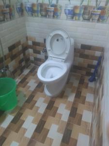a bathroom with a white toilet in a room at Yasin Guest house in Puducherry