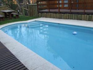 a large blue swimming pool with a ball in it at Manke Apart & Suites in San Martín de los Andes