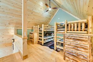 a log cabin with two bunk beds in a room at Modern Cabin with Hot Tub and Sacandaga Lake Access! in Broadalbin