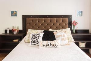 Un dormitorio con una cama con almohadas. en PALERMO, Mejor ubicacion, amplio y luminoso a pasos del shopping, subte y parque en Buenos Aires