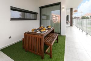 a dining room with a table with food on it at Consolação Wave Beach House in Atouguia da Baleia
