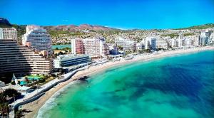 an aerial view of a beach with buildings and the ocean at Corbeta in Calpe