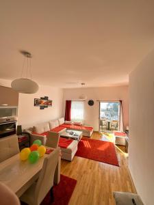 a living room with a couch and a table at Bjelasnica Apartment with the most beautiful view in Bjelašnica