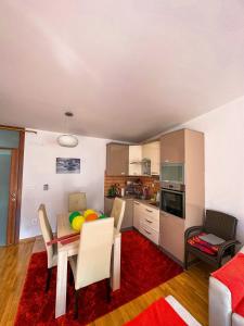 a kitchen and dining room with a table and chairs at Bjelasnica Apartment with the most beautiful view in Bjelašnica +15 photos