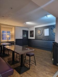 梅爾羅斯的住宿－Dryburgh Arms Pub with Rooms，一间在房间内配有桌椅的餐厅