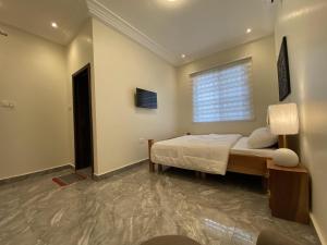 a bedroom with a bed and a window at EAGLE VAULT (THE NEST FACILITY) in Accra