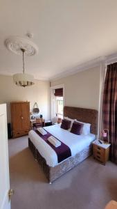 a bedroom with a large bed in a room at Dryburgh Arms Pub with Rooms in Melrose