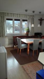 a living room with a dining room table and chairs at Haus Agerer FEWO 2. Stock in Tarrenz
