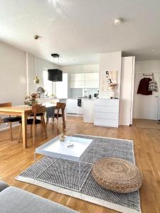 a living room with a table and a kitchen at 46m2 Studio in Rovaniemi