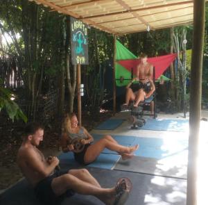 a group of people doing yoga under a pavilion at Lagarto Na Banana Hostel in Pipa
